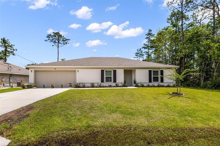 Front exterior of a new home in Palm Coast, Palm Coast, FL, highlighting curb appeal (Image 2). Front exterior of a new home in Palm Coast, Palm Coast, FL, highlighting curb appeal (Image 2).