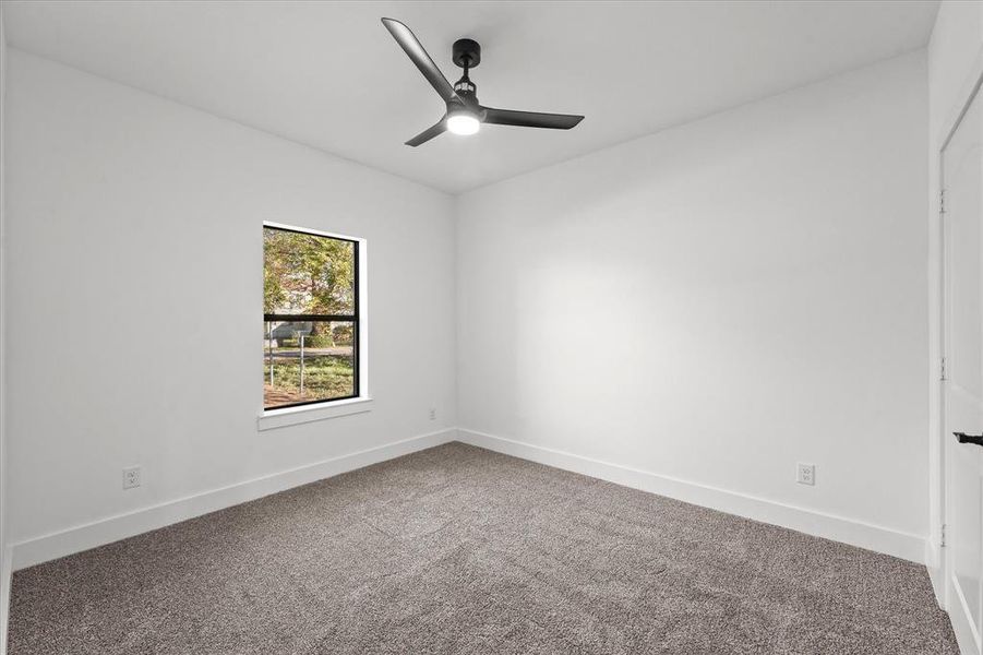 Unfurnished room with ceiling fan and carpet