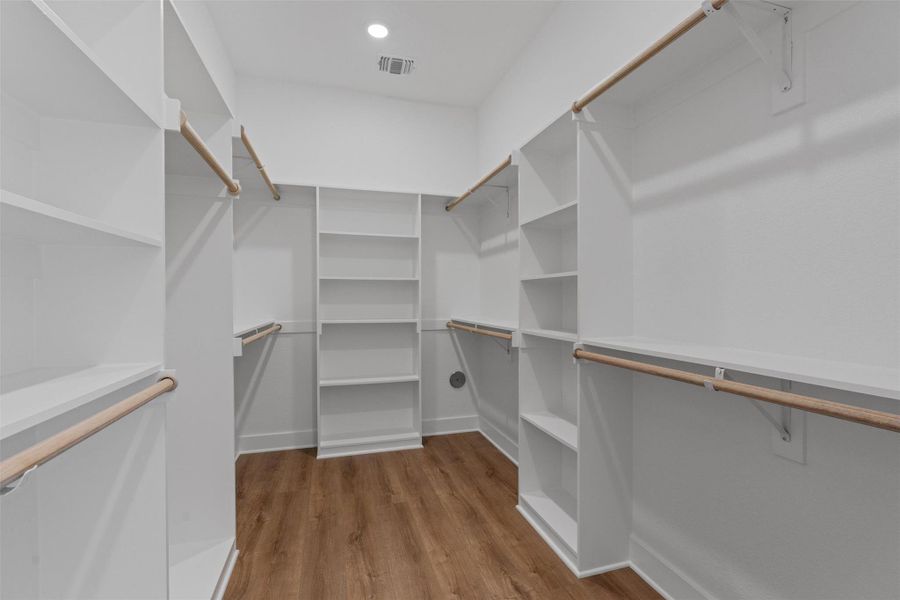 Ample shelving and hanging space defines this generously organized walk-in closet, ready to accommodate any wardrobe. Ample shelving and hanging space defines this generously organized walk-in closet, ready to accommodate any wardrobe.