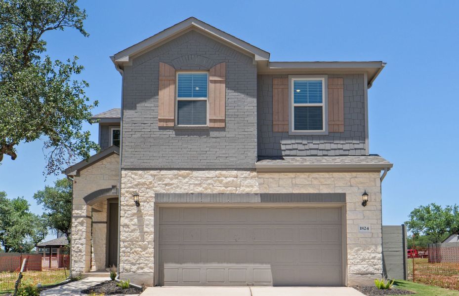 Front exterior of a new home in Wolf Ranch, Georgetown, TX, highlighting curb appeal (Image 2). Front exterior of a new home in Wolf Ranch, Georgetown, TX, highlighting curb appeal (Image 2).