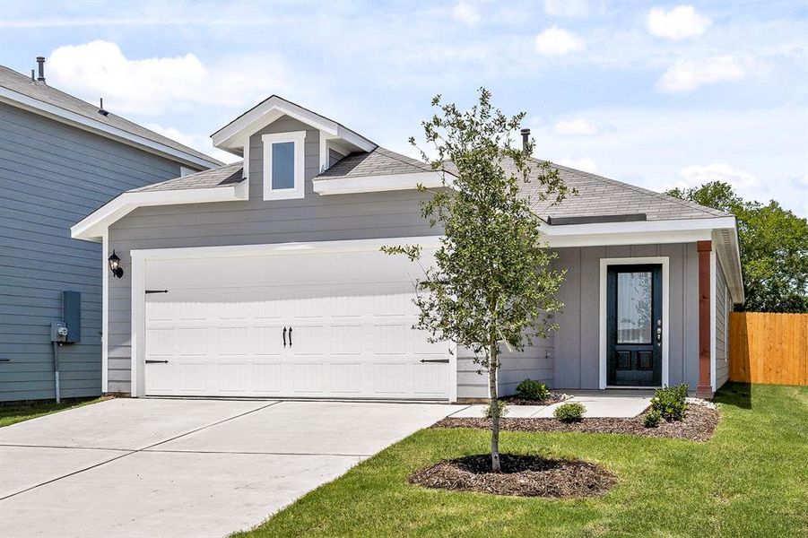 Ranch-style home with a front yard and a garage