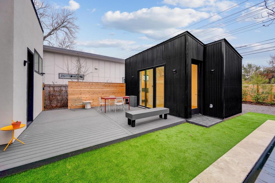 Rear view of property featuring a wooden deck