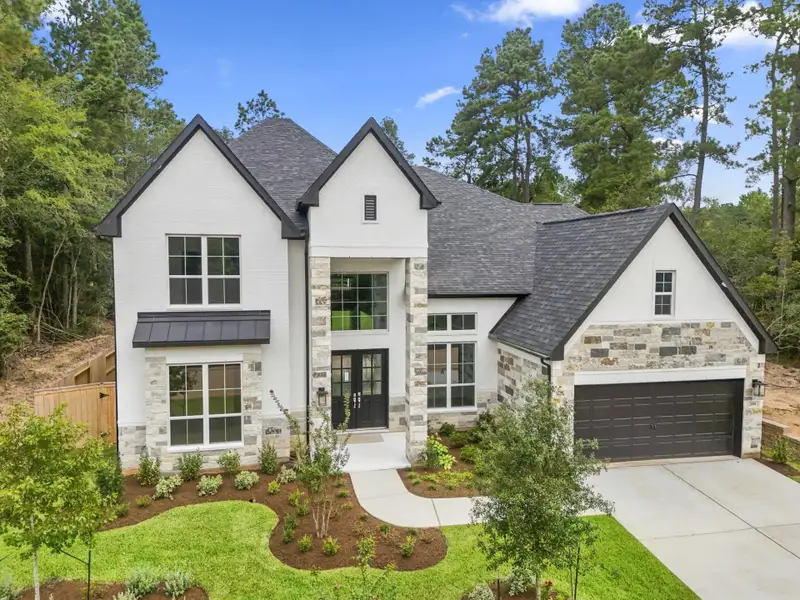 Front exterior of a new home in The Woodlands Hills, Willis, TX, highlighting curb appeal (Image 2). Front exterior of a new home in The Woodlands Hills, Willis, TX, highlighting curb appeal (Image 2).