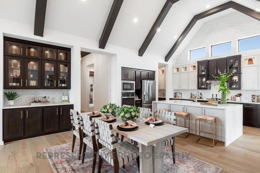 Dining space featuring beam ceiling, light wood-type flooring, high vaulted ceiling, and recessed lighting