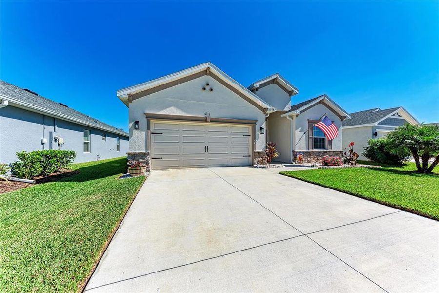 Front exterior of a new home in Aviary at Rutland Ranch, Parrish, FL, highlighting curb appeal (Image 1).