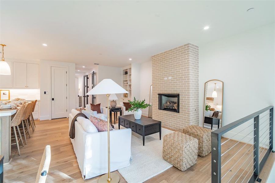 Office area with built in desk and light hardwood flooring