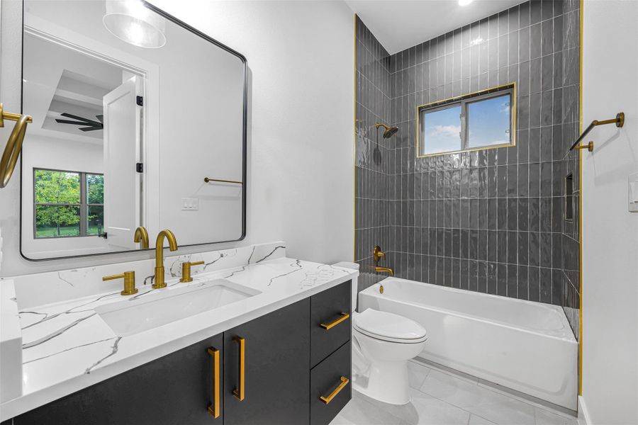 Full bath featuring a vanity, toilet, and shower/tub combination. Full bath featuring a vanity, toilet, and shower/tub combination.