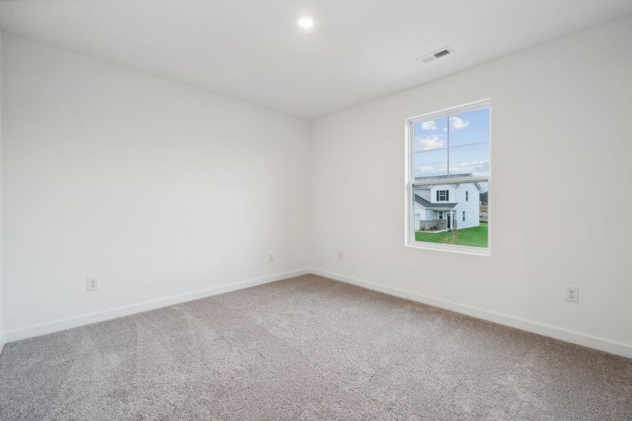 A room with a window and a carpet. A room with a window and a carpet.