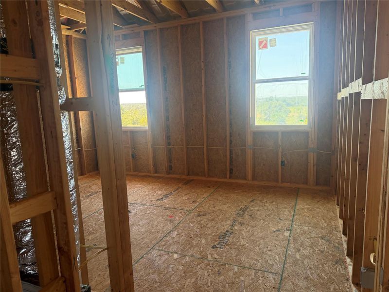 Exposed wood framing and subflooring define this room currently under construction.