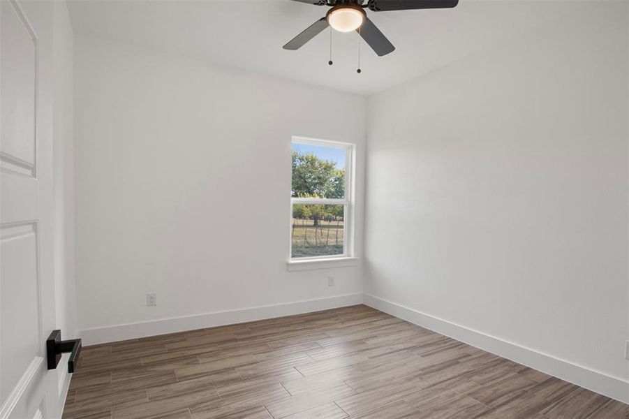 Spare room featuring ceiling fan and light hardwood / wood-style flooring