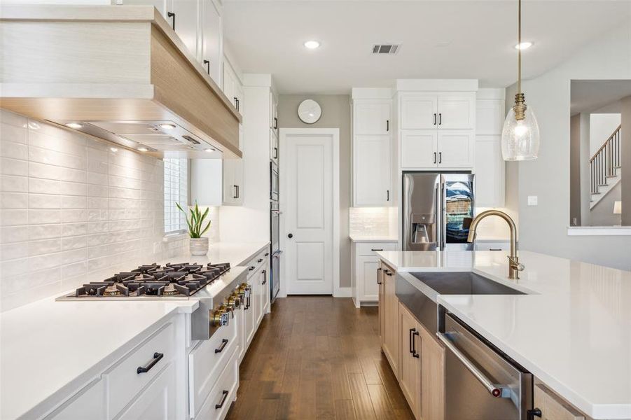 Kitchen featuring white cabinetry, appliances with stainless steel finishes, and dark hardwood / wood-style flooring