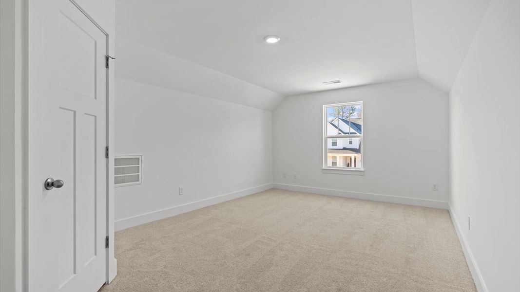 Accomplished design in this restful bedroom featuring plush carpet and oversized window views