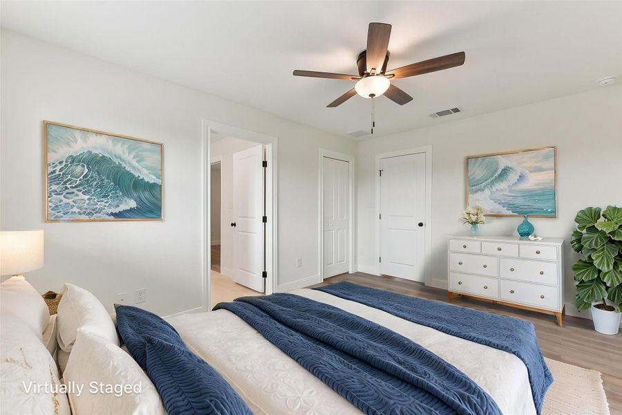 Virtually Staged Bedroom 2 featuring baseboards, wood style finished floors, visible vents, and a ceiling fan