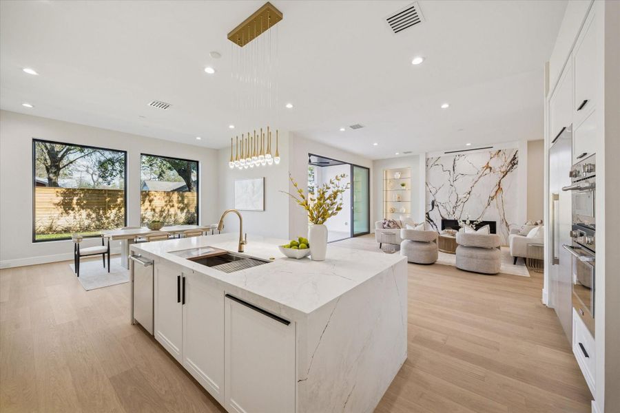 Custom inset cabinetry, complete with deep drawers for pots and pans, enhances both function and aesthetics, delivering a tailored look that integrates seamlessly into the overall kitchen design. Thermador double wall ovens and a full size side by side refrigerator/freezer complete the gourmet Kitchen.