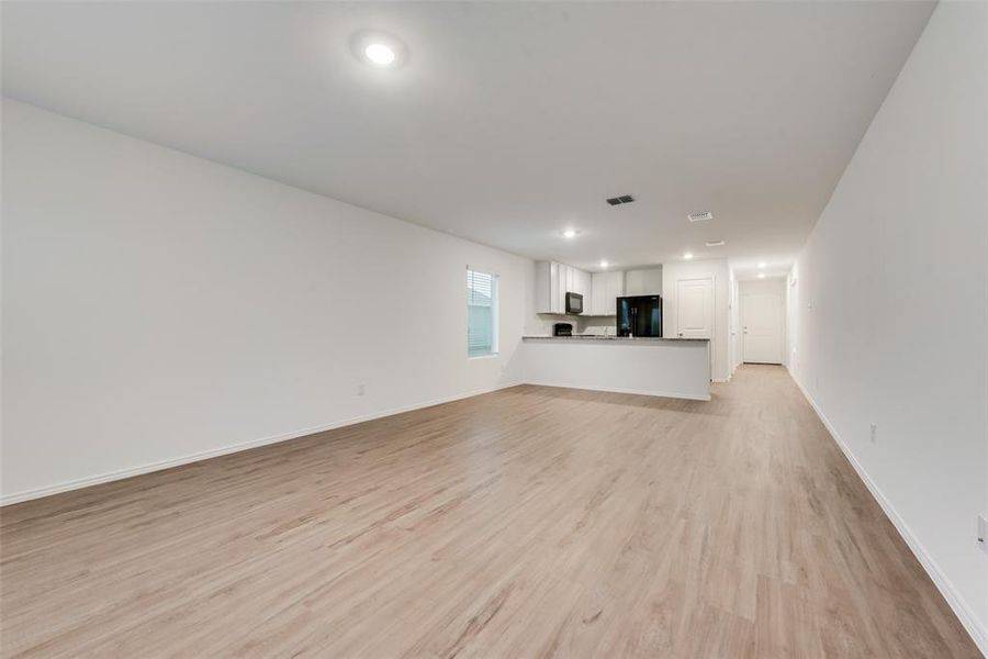 Unfurnished living room with light hardwood / wood-style floors