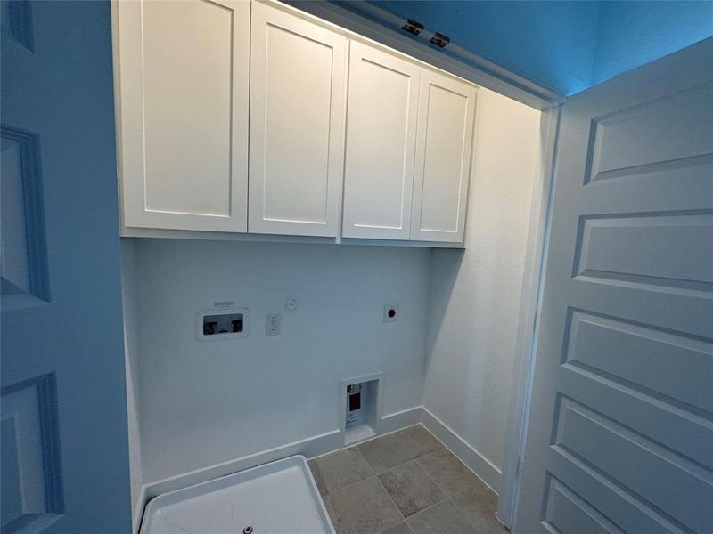 Laundry room featuring cabinets, hookups and located on 3rd floor.