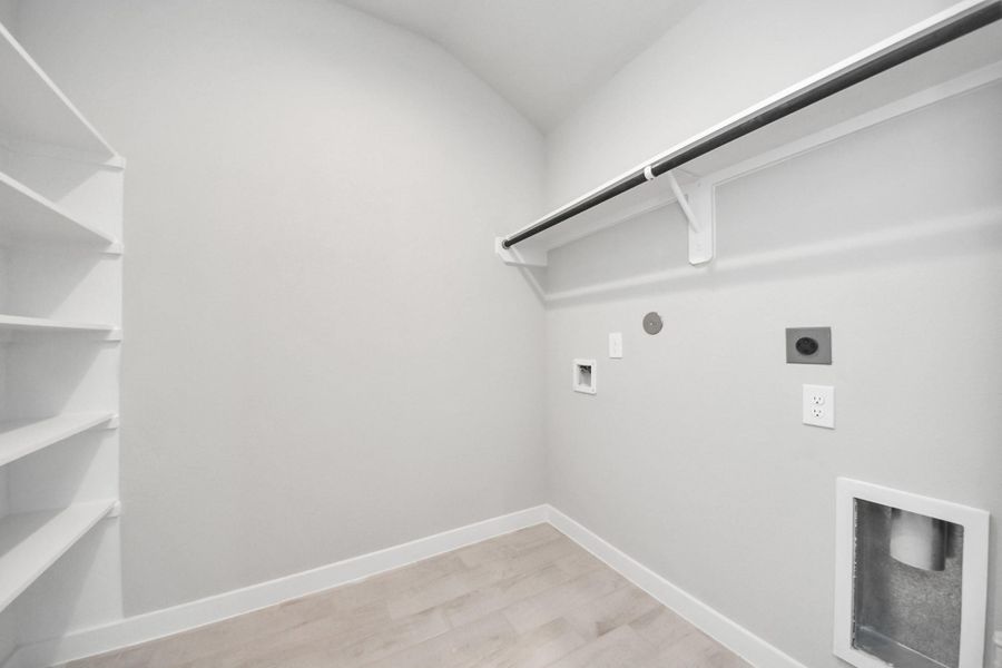 A perfect blend of functionality and comfort. Capture the essence of easy living with a first-floor laundry room, thoughtfully equipped with shelving for effortless organization. Both electric and gas connections available. A perfect blend of functionality and comfort. Capture the essence of easy living with a first-floor laundry room, thoughtfully equipped with shelving for effortless organization. Both electric and gas connections available.