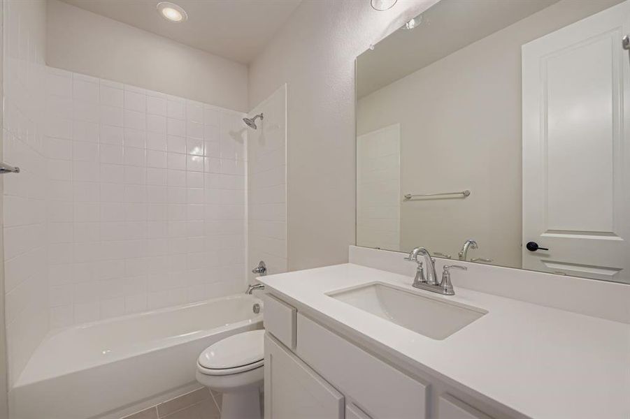 Full bath with washtub / shower combination, vanity, tile patterned floors, and recessed lighting Full bath with washtub / shower combination, vanity, tile patterned floors, and recessed lighting