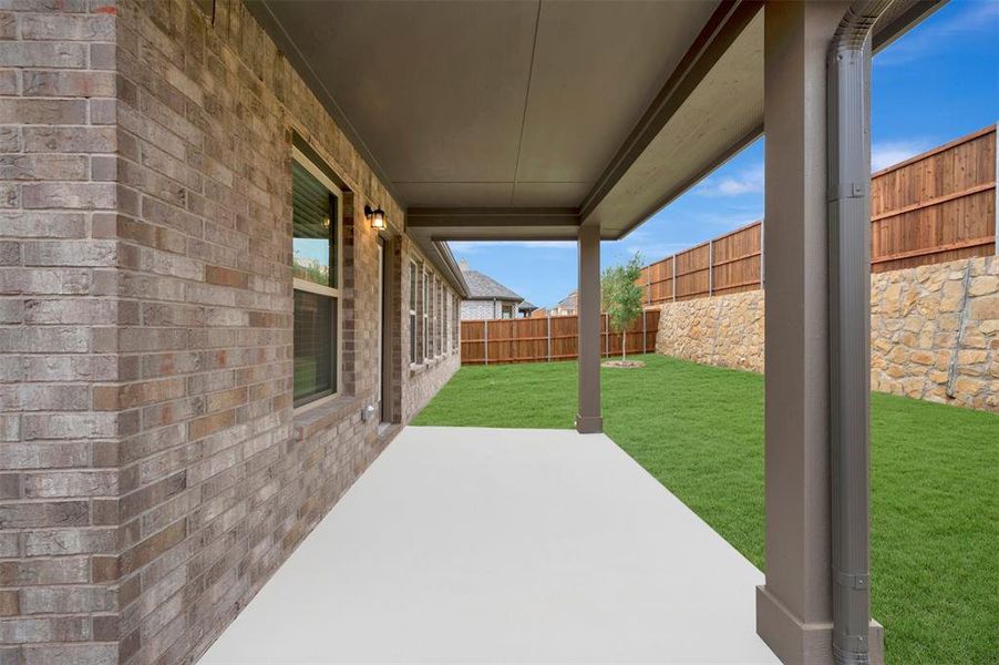 Exterior details and patio area of a home in Woodstone, Providence Village (Image 25).