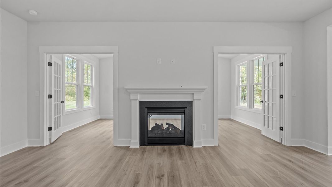 Superior design shines in this open-concept family room with timeless finishes, fireplace, and a modern edge