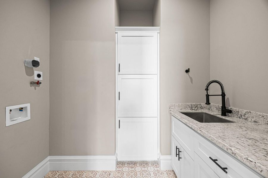 The 2nd floor laundry is equipped with gas or electric connections. Built-in storage, as well as a sink make the laundry a versatile space that has truly been maximized! The 2nd floor laundry is equipped with gas or electric connections. Built-in storage, as well as a sink make the laundry a versatile space that has truly been maximized!