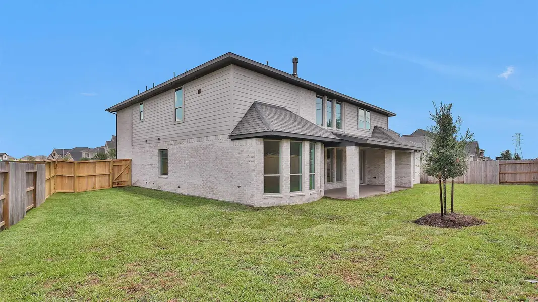 Front exterior of a new home in Katy Court 70', Katy, TX, highlighting curb appeal (Image 2). Front exterior of a new home in Katy Court 70', Katy, TX, highlighting curb appeal (Image 2).