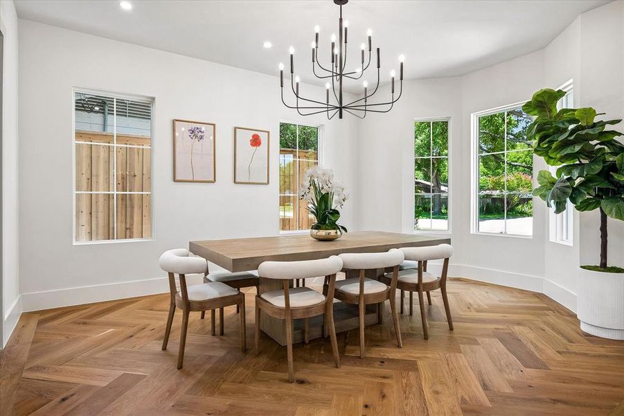 Formal dining, herringbone hardwood floor, multi-window array, chandelier Formal dining, herringbone hardwood floor, multi-window array, chandelier