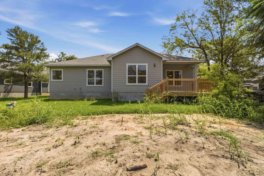 A newly constructed residence features a charming deck, perfect for outdoor relaxation. A newly constructed residence features a charming deck, perfect for outdoor relaxation.