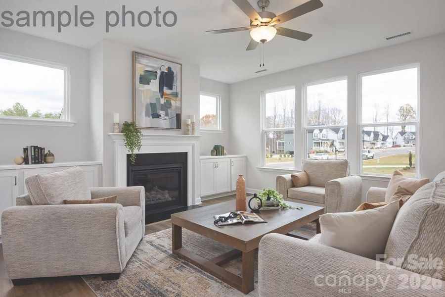 Actual home will have same built ins on either side of fireplace with the high windows