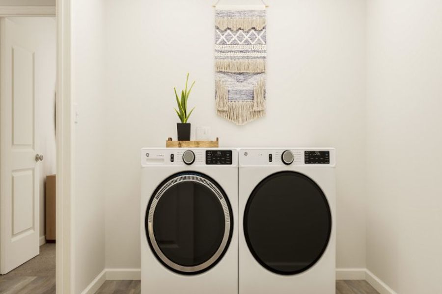 A washing machine and dryer in a room.