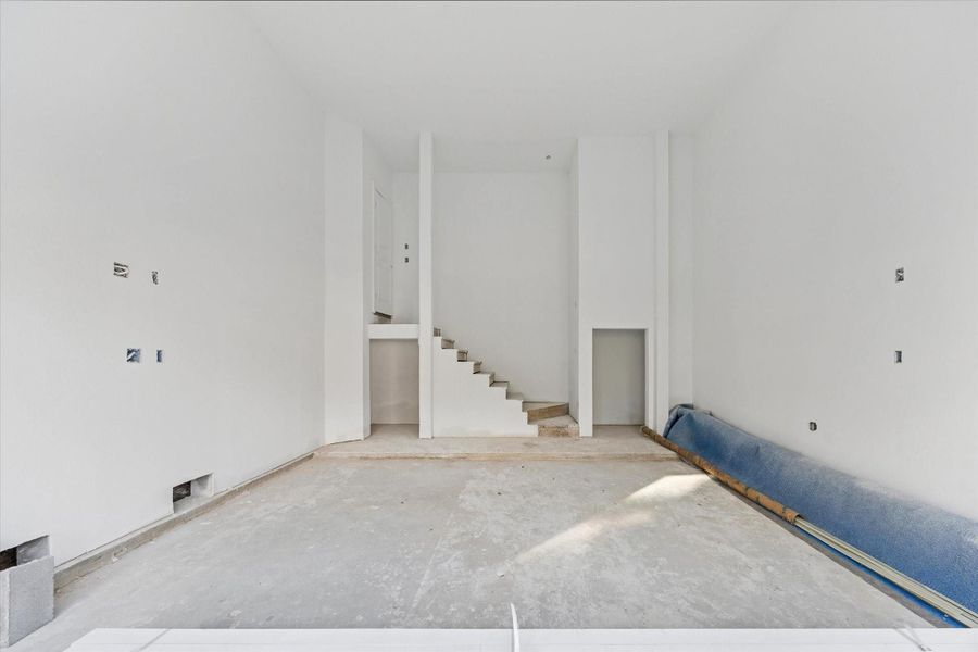 View of the garage with tall ceilings and EV charging capabilities as of December 12, 2025.