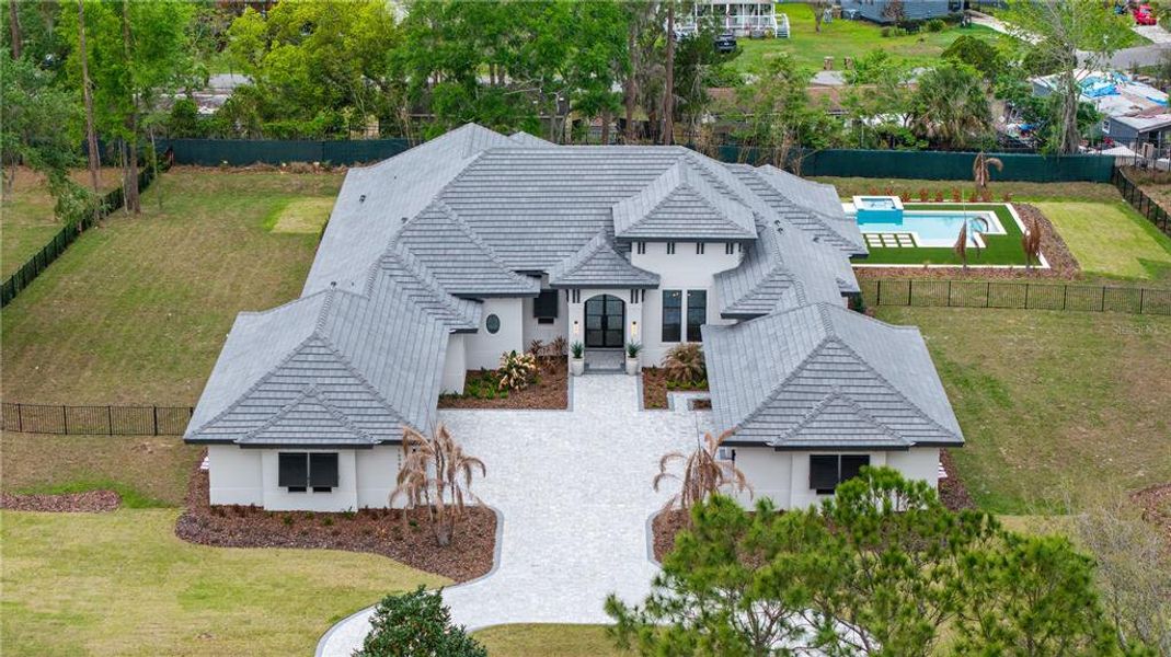 Front exterior of a new home in Bella Collina, Montverde, FL, highlighting curb appeal (Image 2). Front exterior of a new home in Bella Collina, Montverde, FL, highlighting curb appeal (Image 2).