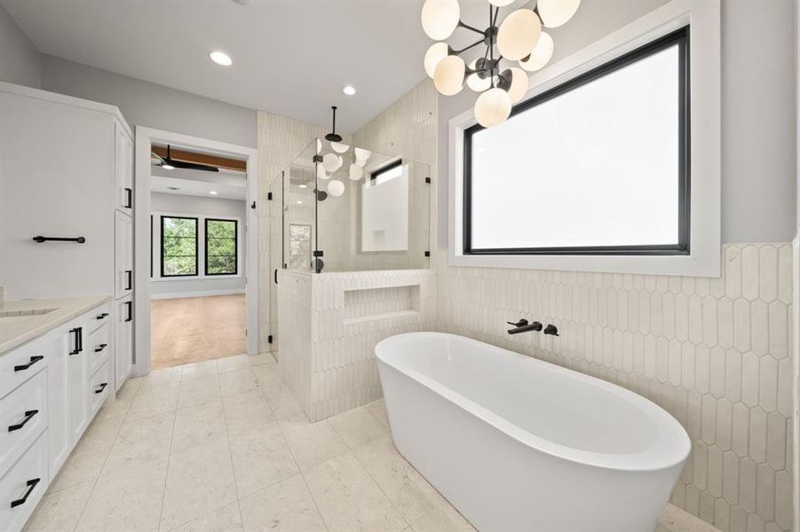 Another view of the main bathroom with the modern chandelier over the soaking tub.