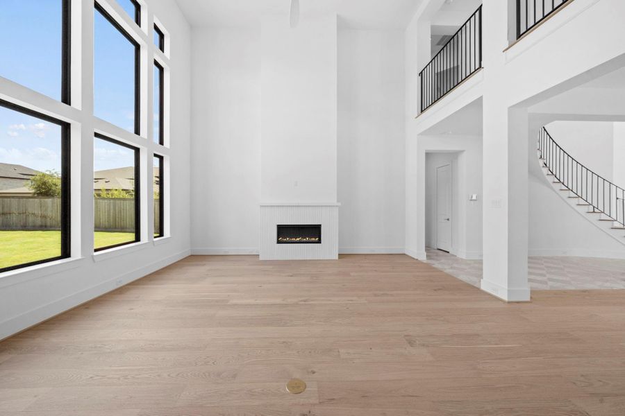 Dramatic living area with soaring ceilings, expansive windows, and abundant natural light.