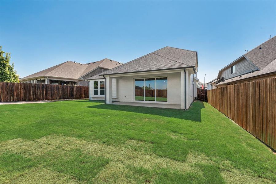 Rear view of property featuring a patio, brick siding, a shingled roof, and a fenced backyard Rear view of property featuring a patio, brick siding, a shingled roof, and a fenced backyard