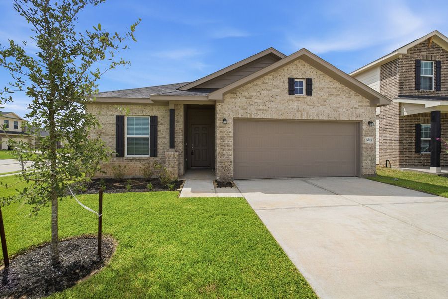Front exterior of a new home in Bluestem, Brookshire, TX, highlighting curb appeal (Image 25).
