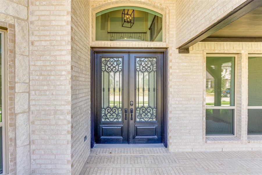 Custom double iron doors with rain glass.