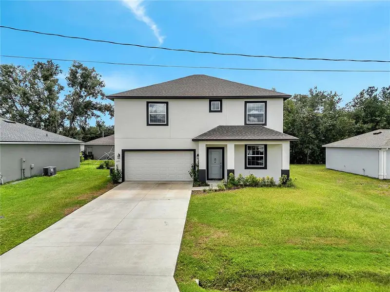 Front exterior of a new home in , Kissimmee, FL, highlighting curb appeal (Image 11).
