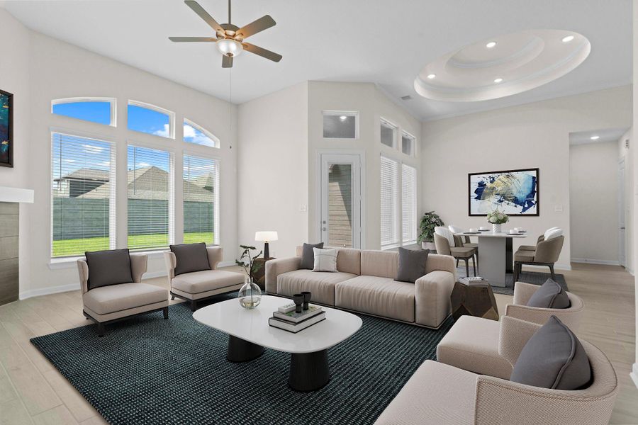 Another angle of the family room showcasing tall windows that fill the space with natural light and offer views of the backyard. *Virtually Staged*