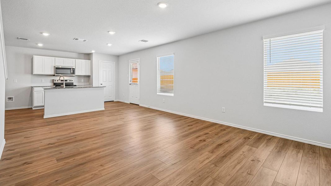 A well-lit, open-concept living space seamlessly connects the kitchen and dining areas.