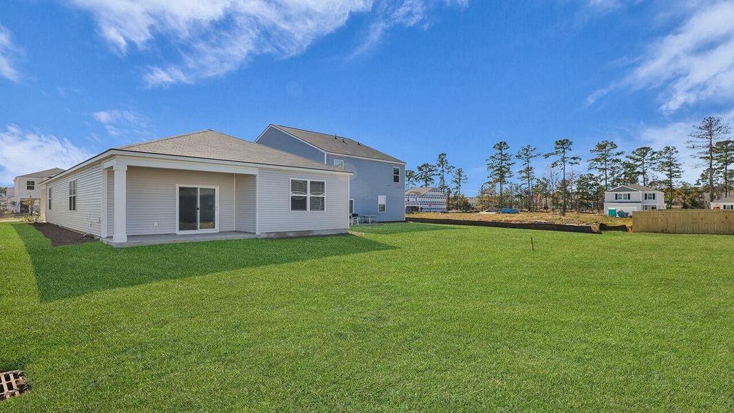 Exterior details and patio area of a home in Pine Hills at Cane Bay, Summerville (Image 21).