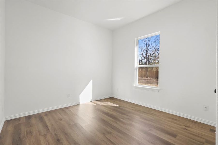 Empty room featuring wood-type flooring