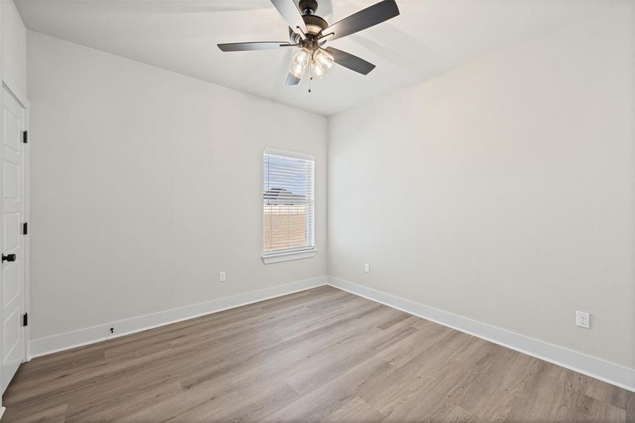 Empty room with light wood-style flooring and a ceiling fan