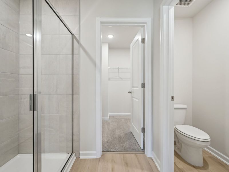 Relax in the spacious primary suite featuring an ensuite bath with dual sinks and a walk-in closet.