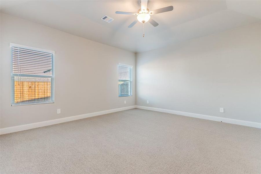 Unfurnished room with light carpet and ceiling fan Unfurnished room with light carpet and ceiling fan