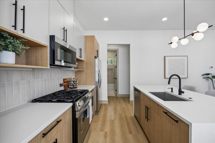 Soft neutral finishes, under cabinet lighting, stainless steel appliances, and abundant storage make this kitchen as functional as it is beautiful. Soft neutral finishes, under cabinet lighting, stainless steel appliances, and abundant storage make this kitchen as functional as it is beautiful.