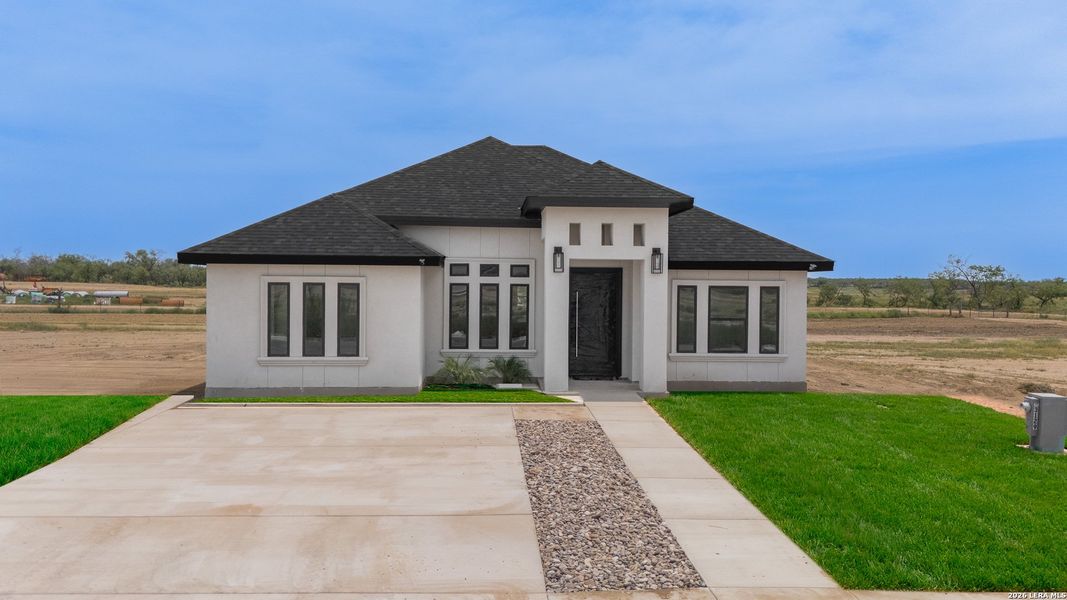 Front exterior of a new home in , Eagle Pass, TX, highlighting curb appeal (Image 2). Front exterior of a new home in , Eagle Pass, TX, highlighting curb appeal (Image 2).