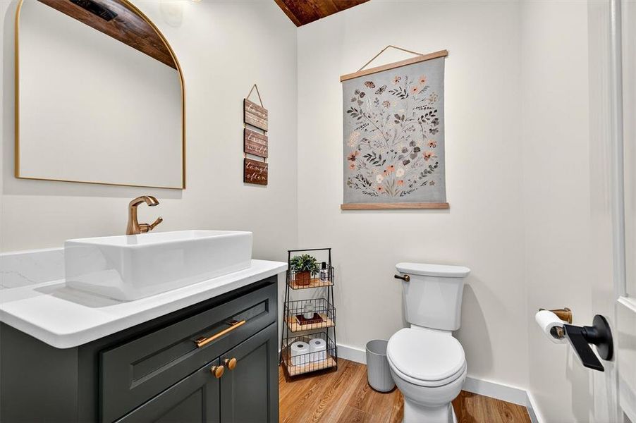 Half bath with light wood-style floors and vanity Half bath with light wood-style floors and vanity
