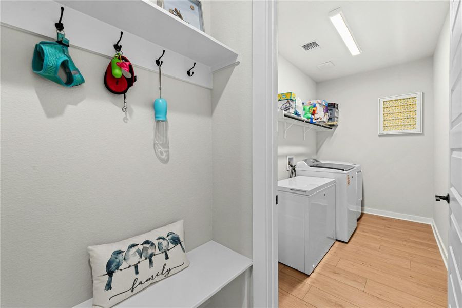 Laundry area with connected mud area conveniently located through the master closet.