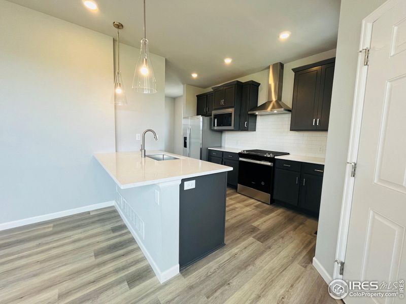 White Quartz countertops with white subway tile.  Refridgerator is included!